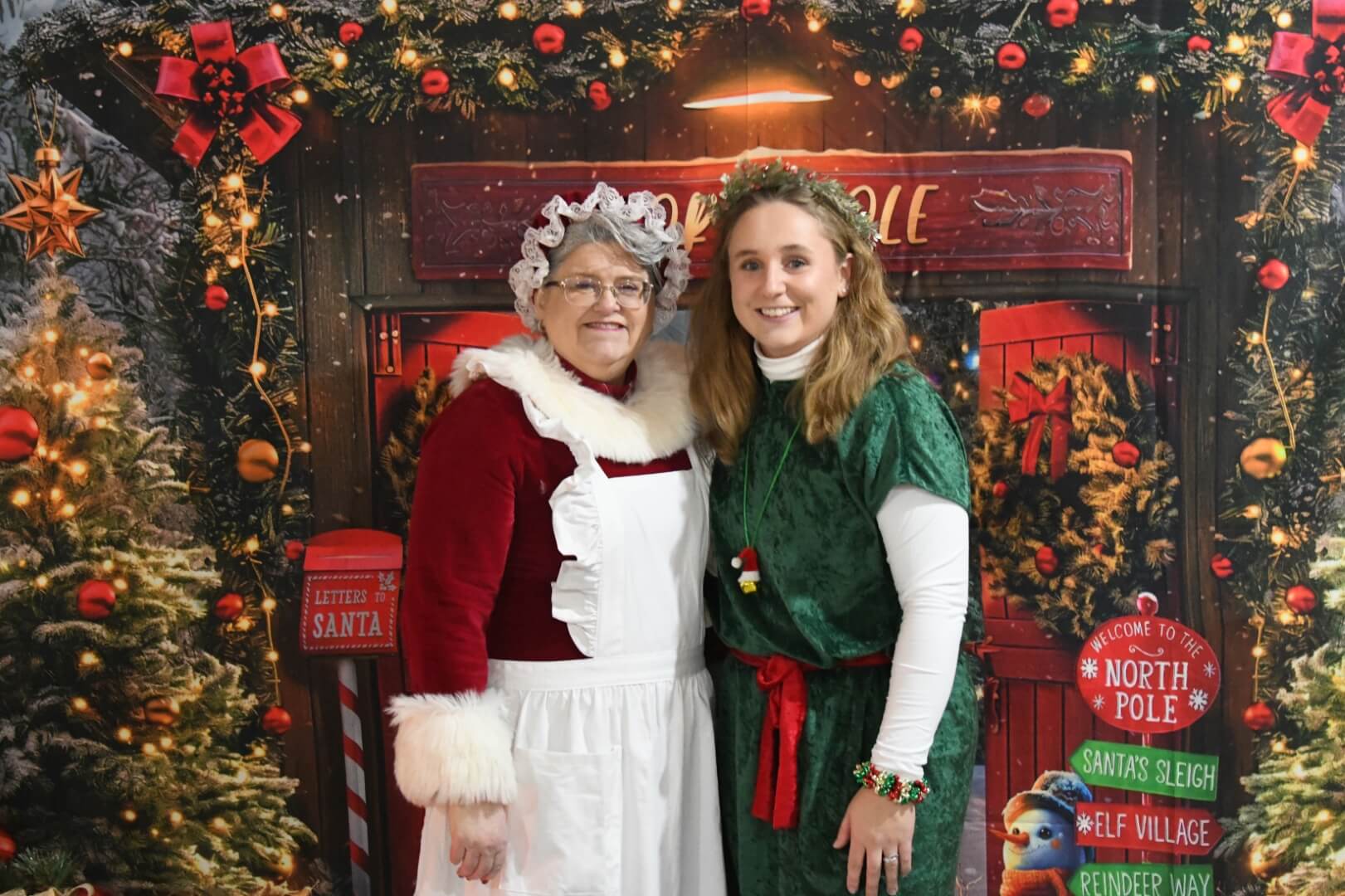 mrs claus and a tall elf