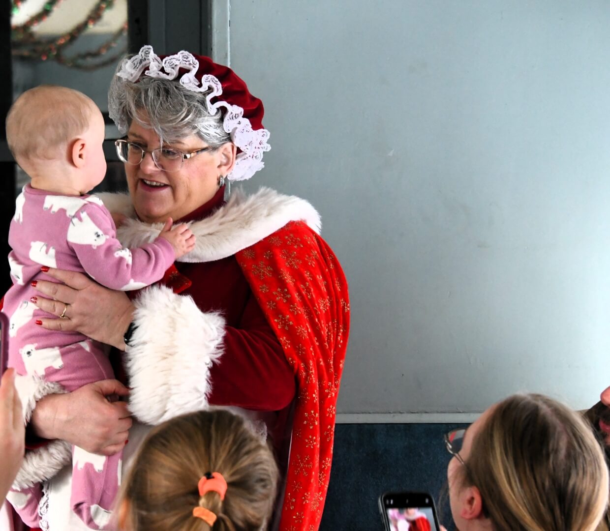 mrs claus talking to a baby